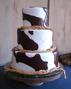 Three tier country and western style wedding cake, decorated to look like cow hide print