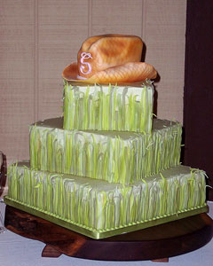 Three tier western style, square green wedding cake with a handmade orange fondant cowboy hat