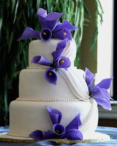 Three tier purple and white fondant wedding cake
