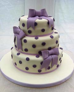 Round three tier white and purple polka dot wedding cake