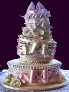 Artistic and creative three tier topsy turvy pink and white wedding cake