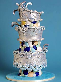 Unique, three tier silver and blue wedding cake, decorated with interesting forms of fondant