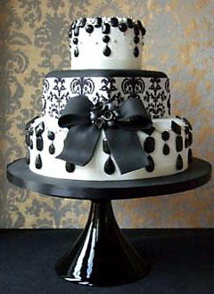 Three tier black wedding cake made to look like a spooky wedding cake