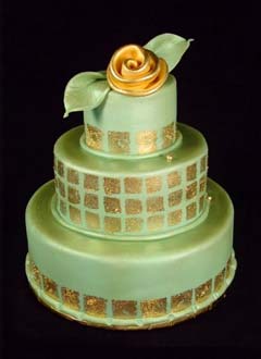 Round three tier green and gold retro style fondant wedding cake, decorated with gold leaf style