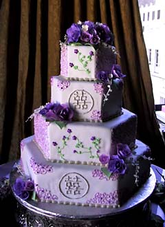 Four tier hexagon shape purple oriental wedding cake, decorated with intricate purple decorations