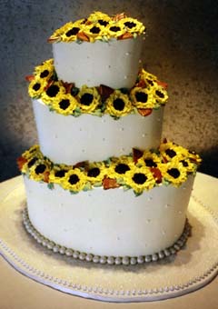 Three tier white buttercream oval shaped wedding cake