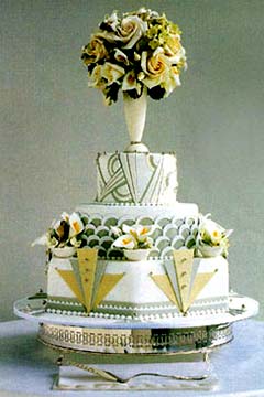 Three tier art deco olive green and white wedding cake decorated with gold and green 1920's style shapes and patterns
