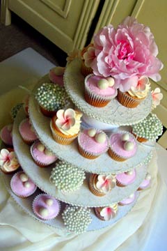 Four tiered white and pink wedding cupcakes