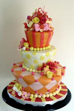 Three tier topsy turvy orange, red, yellow and pink fun cake design