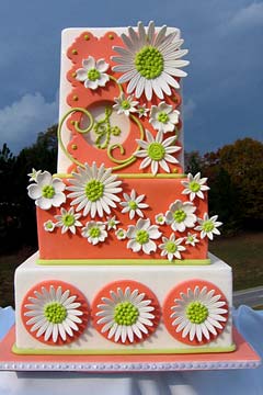 Three tier white and orange 1960's style wedding cake