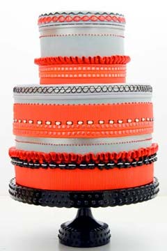 Two tier orange, white and silver retro wedding cake
