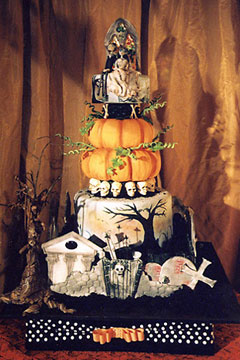 Four tier halloween graveyard cake with a pumpkin cake as the second tier