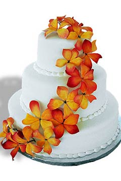 Three tier round fondant wedding cake design decorated with orange tropical Hawaiian flowers