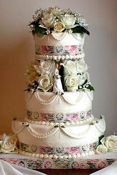 Three tier Viictorian style roses and lace wedding cake