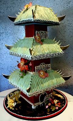 Green Chinese Pagoda three tiered wedding cake, decorated with gumpaste flowers abd a gold dragon