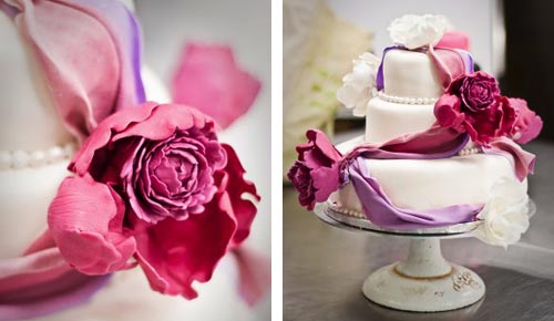 Small, round romantic three tier fondant wedding cake decorated with the colours of spring