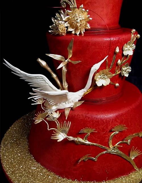 Unusual three tier red wedding asian cake decorated with gold cherry blossoms