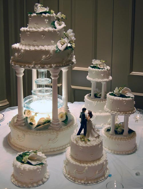 Four tier water fountain, butter cream wedding cake decorated with white hand made sugar paste calla lillies