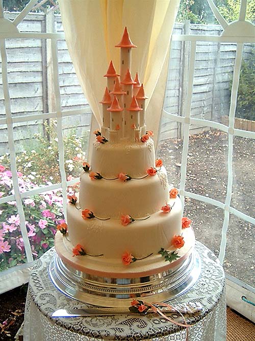 Huge three tier cream and orange wedding cake castle