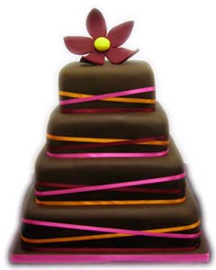 Elegant brown four tier square wedding cake decorated with thin pink, orange and burgundy satin ribbons