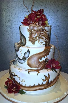 Three tier Chinese dragon and Phoenix wedding cake design, decorated with rich red Cymbidium Orchids