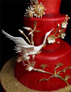 Unusual three tier red wedding asian cake decorated with gold cherry blossoms