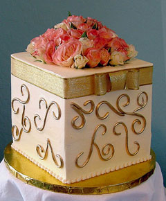 A square wedding cake made to look like a gift box cake