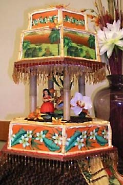 Three tier Hawaiian wedding cake design, hand painted with hawaiian florals and scenery
