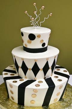 Three tier mad hatter black and white weddiing cake decorated with silver polka dots