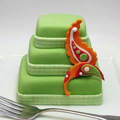Retro three tier mini green wedding cake embellished with a vibrant orange