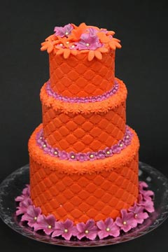 Small three tier retro orange and pink funky wedding cake