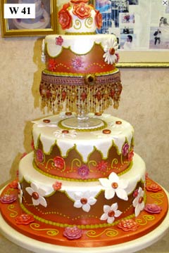 Two tier art deco white and orange wedding cake is so stunning