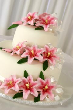 classic two tier white fondant wedding cake with tiger lillies