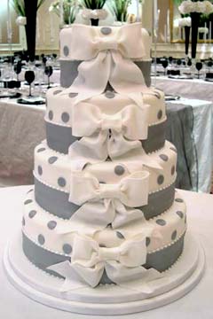 Four tier white and silver wedding cake with silver polka dots