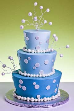 Three tier funky blue wedding cake decorated with white polka dots