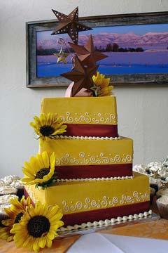 Three tier square yellow wedding cake with big yellow sunflowers