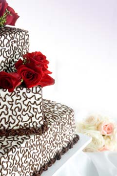 Angled off centre, square wedding cakes with brown buttercream swiggles and swirls